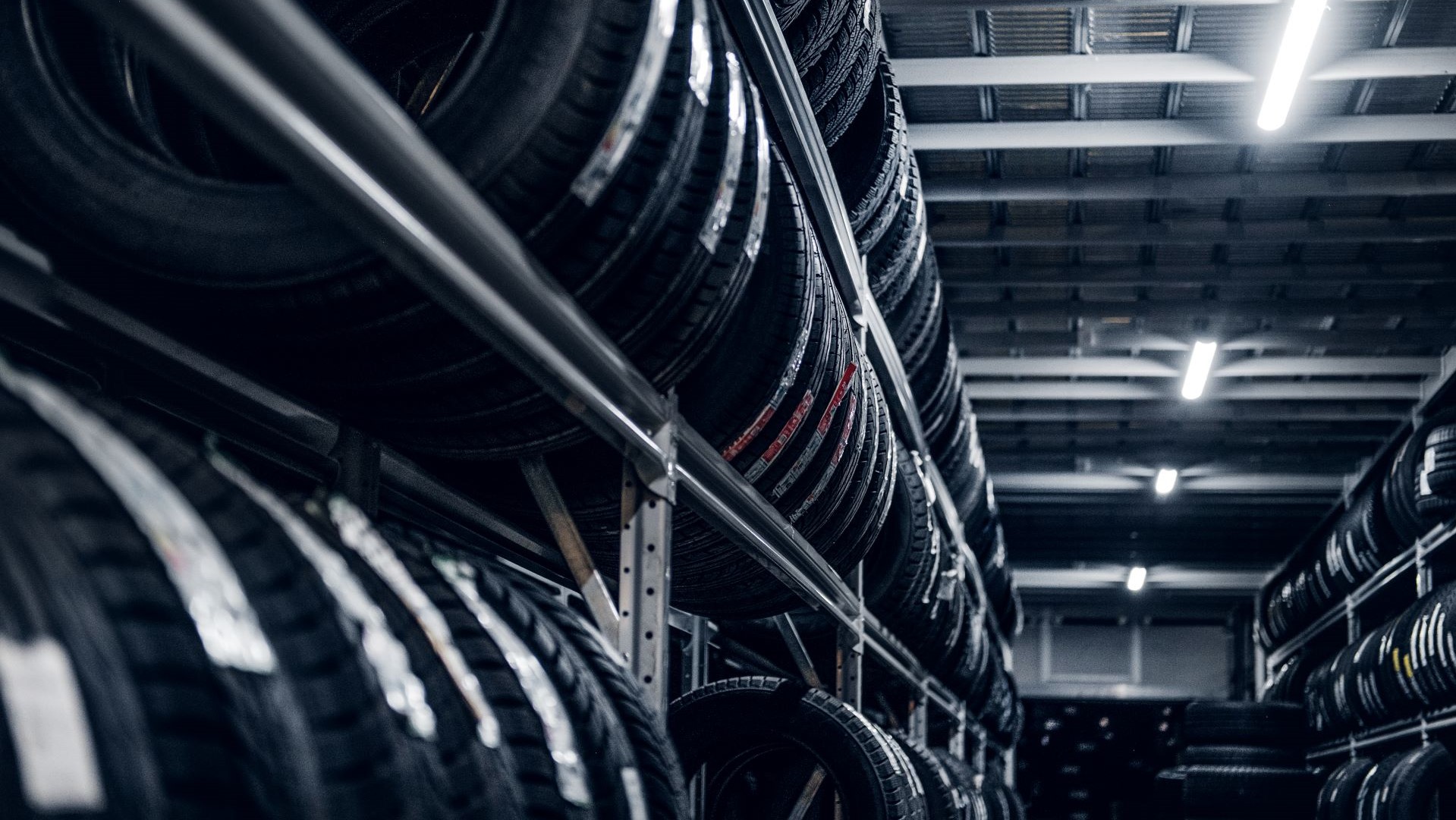 Multiple racks of tires in a tire warehouse.