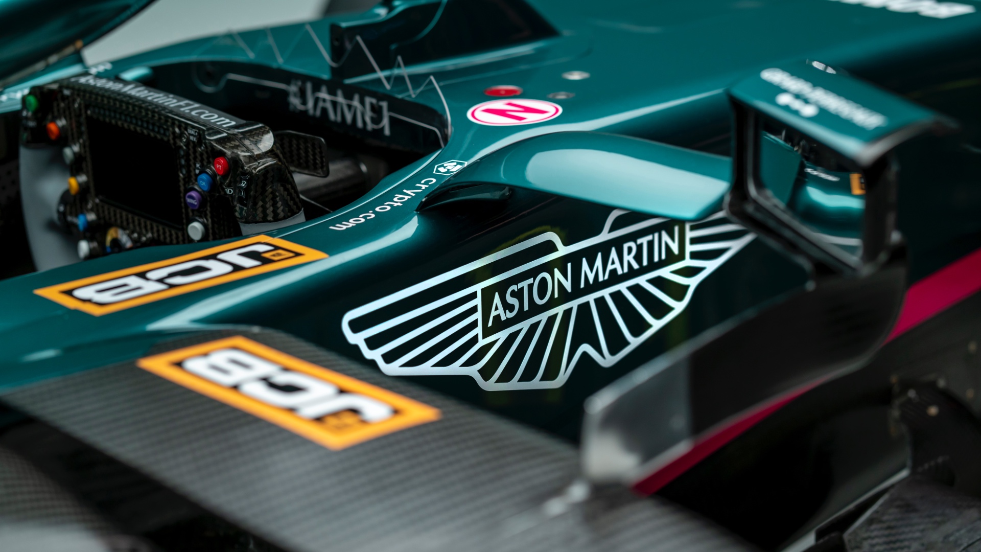 Aston's steering wheel within the cockpit.