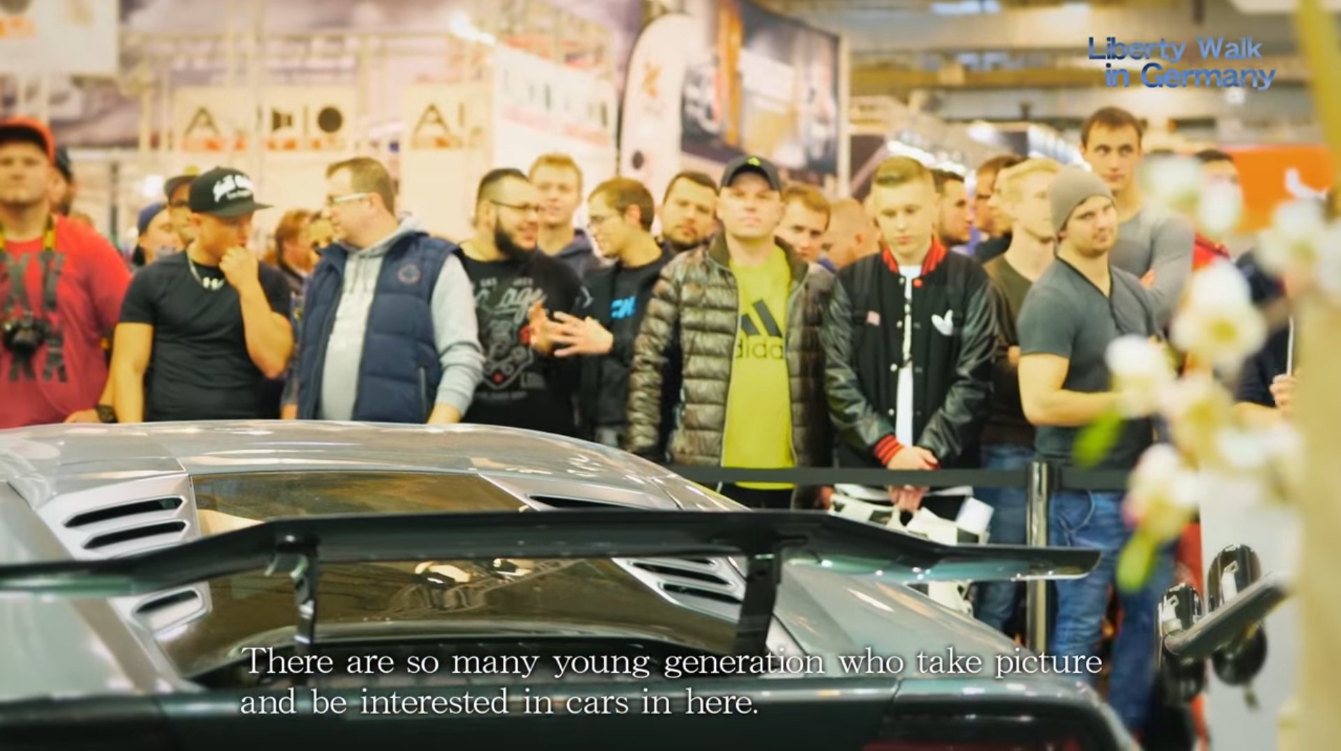 A crowd gathers around the Liberty Walk booth at the 2016 Essen Motor Show.