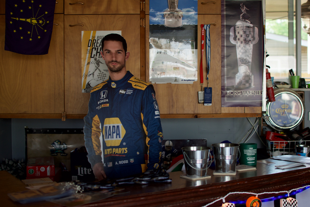 The inside of a man's garage decorated with decades of racing memorabilia.